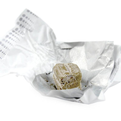 Luxurious Tartuflanghe truffelpralines featuring Dolce d'Alba truffles, creamy white chocolate, and weighing approximately 14g each, packaged in a 25 kg box